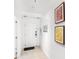 Clean hallway with neutral decor, tiled floors, and contemporary wall art at 7650 Whisper Way # 104, Reunion, FL 34747