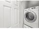 This laundry room has a stacked washer and dryer to save space at 7650 Whisper Way # 104, Reunion, FL 34747