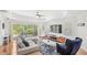 Open-concept living room features hardwood floors, neutral tones, and sliding glass doors to the patio at 7650 Whisper Way # 104, Reunion, FL 34747
