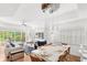 Open-concept living area with modern furnishings, dining space, and access to outdoor patio at 7650 Whisper Way # 104, Reunion, FL 34747