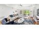 Bright living room features a tray ceiling, hardwood floors, and sliding glass doors to the outside at 7650 Whisper Way # 104, Reunion, FL 34747