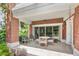 Charming brick patio with tile flooring, cozy seating, and serene outdoor ambiance at 7650 Whisper Way # 104, Reunion, FL 34747