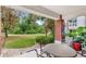 Private covered patio featuring an outdoor seating area, brick column and view of the grounds at 7650 Whisper Way # 104, Reunion, FL 34747