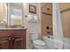 Bright bathroom with a shower/tub combo, a dark wood vanity, a granite countertop, and neutral color tiles at 796 Desert Mountain Ct, Reunion, FL 34747