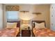 Well-decorated bedroom featuring twin beds, side tables, and warm lighting, creating a cozy and inviting space at 796 Desert Mountain Ct, Reunion, FL 34747