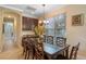 Bright dining room with a large window, elegant lighting, and a dining table with seating for eight at 796 Desert Mountain Ct, Reunion, FL 34747