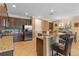 Spacious kitchen with granite countertops, stainless steel appliances, a breakfast bar and tile flooring at 796 Desert Mountain Ct, Reunion, FL 34747