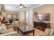 Inviting living room with neutral furniture, tv, and view into dining area at 796 Desert Mountain Ct, Reunion, FL 34747