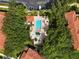 Aerial view showcasing a sparkling community pool, hot tub and lush landscaping at 8507 Crystal Cove Loop, Kissimmee, FL 34747