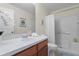 Clean bathroom features a tub and shower combo with white tile, framed mirror and vanity at 8507 Crystal Cove Loop, Kissimmee, FL 34747