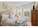 Serene bedroom with natural light, neutral decor and a plush queen-sized bed at 8507 Crystal Cove Loop, Kissimmee, FL 34747