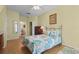 Comfortable bedroom featuring a decorative metal bed frame, wood floors, and a ceiling fan for added comfort at 8507 Crystal Cove Loop, Kissimmee, FL 34747