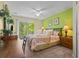 Comfortable bedroom featuring a queen bed, sliding glass door, and bright green accent wall at 8507 Crystal Cove Loop, Kissimmee, FL 34747