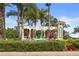 Community entrance with lush greenery and manicured flower beds at a landscaped entrance at 8507 Crystal Cove Loop, Kissimmee, FL 34747