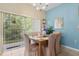 Cozy dining area with chandelier lighting and a large window overlooking a lush exterior at 8507 Crystal Cove Loop, Kissimmee, FL 34747