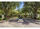 Entrance gate with lush greenery and flower beds at a private community entrance at 8507 Crystal Cove Loop, Kissimmee, FL 34747