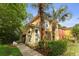 Exterior elevation featuring a neutral-colored home with a sidewalk and manicured landscape at 8507 Crystal Cove Loop, Kissimmee, FL 34747