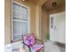Inviting front porch area with cushioned chair, creating a cozy and welcoming entrance at 8507 Crystal Cove Loop, Kissimmee, FL 34747
