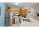 Efficient kitchen with stainless steel appliances, light wood cabinetry, and ample counter space at 8507 Crystal Cove Loop, Kissimmee, FL 34747