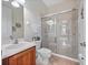 This bathroom boasts a tiled shower, wood vanity, and chrome fixtures at 8531 Cypress Hollow Ct, Sanford, FL 32771