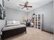 This cozy bedroom features a ceiling fan, a large bookcase, and a desk at 8531 Cypress Hollow Ct, Sanford, FL 32771