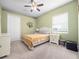 Comfortable bedroom with a ceiling fan, carpet floors, and a window providing natural light at 8531 Cypress Hollow Ct, Sanford, FL 32771