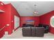 Bonus room features red walls, carpet floors, and a window for natural light at 8531 Cypress Hollow Ct, Sanford, FL 32771