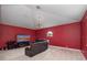 Bonus room features red walls, carpet floors, and a window for natural light at 8531 Cypress Hollow Ct, Sanford, FL 32771