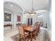 Elegant dining room with a large wooden table, ornate chairs, and sophisticated chandeliers at 8531 Cypress Hollow Ct, Sanford, FL 32771