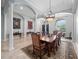 Elegant dining room with a large wooden table, ornate chairs, and sophisticated chandeliers at 8531 Cypress Hollow Ct, Sanford, FL 32771