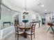 Cozy dining room with a round table, chandelier, and a view to the kitchen at 8531 Cypress Hollow Ct, Sanford, FL 32771