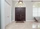 Welcoming foyer with travertine floors, a chandelier, and a view of the front doors at 8531 Cypress Hollow Ct, Sanford, FL 32771