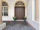 Elegant entryway with double doors, arched window, and decorative plants at 8531 Cypress Hollow Ct, Sanford, FL 32771