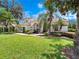 Beautiful property with manicured lawn, lush landscaping, and architectural details at 8531 Cypress Hollow Ct, Sanford, FL 32771