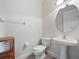 This half bathroom features a pedestal sink, toilet, and tile floors at 8531 Cypress Hollow Ct, Sanford, FL 32771