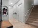 Hallway with tile floors, a staircase, and neutral colored walls with white trim at 8531 Cypress Hollow Ct, Sanford, FL 32771