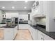 Bright, white kitchen with granite countertops and stainless steel appliances at 8531 Cypress Hollow Ct, Sanford, FL 32771