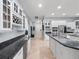 Well-appointed kitchen with white cabinets, granite counters, stainless appliances, and adjacent dining area at 8531 Cypress Hollow Ct, Sanford, FL 32771