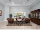 Inviting living room featuring leather seating, a decorative rug, and view to the outdoor living space at 8531 Cypress Hollow Ct, Sanford, FL 32771