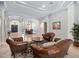 Elegant living room featuring leather seating with beautiful entryway and formal dining area at 8531 Cypress Hollow Ct, Sanford, FL 32771