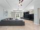Comfortable living room with large windows, stylish curtains, and a modern entertainment center at 8531 Cypress Hollow Ct, Sanford, FL 32771