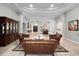 Spacious living room with elegant archways, marble floors and stylish leather furniture at 8531 Cypress Hollow Ct, Sanford, FL 32771