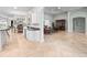 Open floorplan showing kitchen with a bar, dining area, and living room with leather furniture at 8531 Cypress Hollow Ct, Sanford, FL 32771