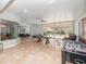 Large living room offers tile floors, a ping pong table, foosball, and sliding glass doors to the pool at 8531 Cypress Hollow Ct, Sanford, FL 32771