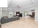 Spacious living room featuring stone floors, high ceilings, and a large built-in entertainment center at 8531 Cypress Hollow Ct, Sanford, FL 32771