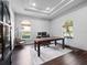 Bright office with natural light, hardwood floors, and a custom desk at 8531 Cypress Hollow Ct, Sanford, FL 32771