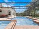 Gorgeous pool area with a screened enclosure and ample seating for entertaining at 8531 Cypress Hollow Ct, Sanford, FL 32771