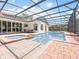 Beautiful screened-in pool area with spa, outdoor seating, and seamless indoor/outdoor flow at 8531 Cypress Hollow Ct, Sanford, FL 32771