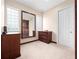 Walk-in closet offers carpet and ample storage space with wooden dressers and a mirror at 8531 Cypress Hollow Ct, Sanford, FL 32771