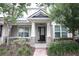 Charming front porch with stone accents and manicured landscaping, offering a welcoming entrance at 8670 Vedder Ln, Orlando, FL 32832